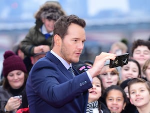 Chris Pratt taking a selfie with fans