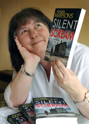 Angela pictured in 2015 with her debut novel, Silent Scream