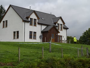 Police officer outside house