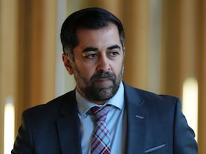 Humza Yousaf walks through Holyrood corridor