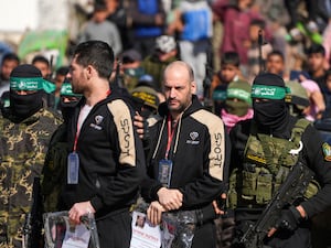 The hostages being escorted by Hamas fighters