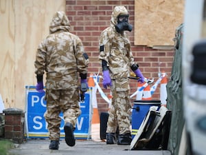 Members of the military wearing protective clothing