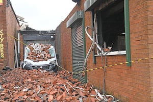 Piles of bricks seen in Haynes Lane in the aftermath of the fire