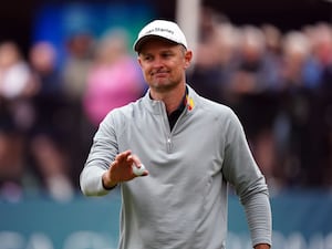 Justin Rose reacts after holing a putt