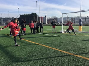 School footballers with Harriers players and manager Phil Brown watching up and coming goalkeeper and former Stourport High student Josh Bishop in training