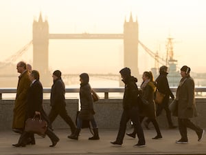 Commuters in central London as they cross London Bridge