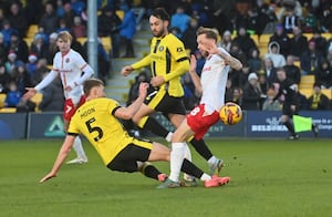 Charlie Lakin challenges for the ball.