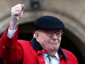 Former far-right National Front party leader Jean-Marie Le Pen clenches his fist at the statue of Joan of Arc in Pari