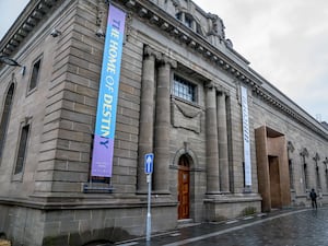 Exterior view of Perth Museum, which has a vertical banner reading "The Home of Destiny" hanging down it