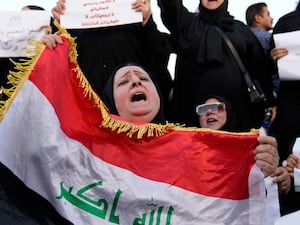 A female protester holds a flag