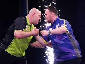 Michael van Gerwen and Luke Littler hug