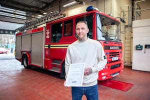 Tom Alexander was given the award after saving three dogs from a burning house. Photo: West Midlands Fire Service