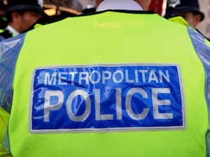 A Metropolitan Police badge on a high vis jacket