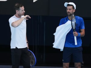 Andy Murray, left, talks with Novak Djokovic during a training session