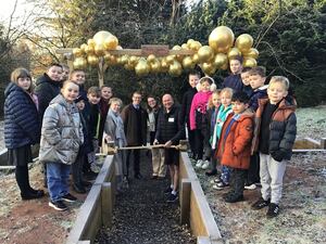 Pupils celebrate the opening of their wellbeing garden as creator Clive Heath cuts the ribbon with (from left) Julia Bell, James Price, and Vicki Harrison