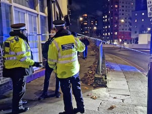 Police at the scene in Woolwich, south east London where a 14-year-old boy died after he was stabbed on a bus