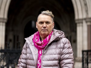 Dale Vince outside the Royal Courts of Justice wearing a puffer jacket and scarf