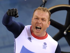 Sir Chris Hoy celebrating in cycling gear