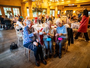 Ladies laugh as they enjoy knitting in the Orchard Room on the Highgrove estate during a Winter Warmers session