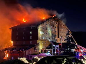 Firefighters work to extinguish a fire in a hotel at the ski resort of Kartalkaya in Bolu province, in north-west Turkey