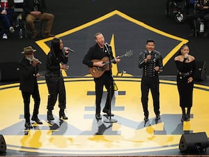 Chris Martin and members of the Universal Gospel Choir perform