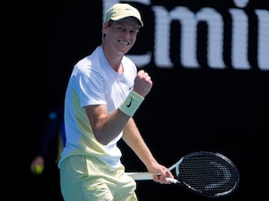 Jannik Sinner clenches his fist after winning a point