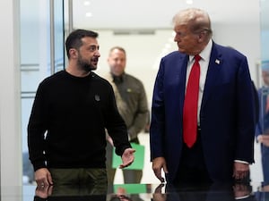 Volodymyr Zelensky and Donald Trump speak as they leave a building together