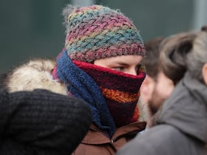 Dr Beth Upton with her face covered by a scarf