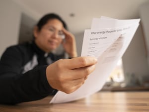 A woman looking at an energy bill