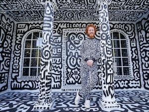 Sam Cook standing in front of his Doodle house