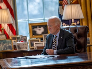 US President Joe Biden at his desk in the Oval Office at the White House