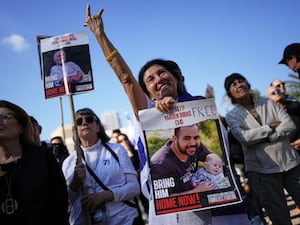 Israelis react as they watch a broadcast of the release of American-Israeli Keith Siegel