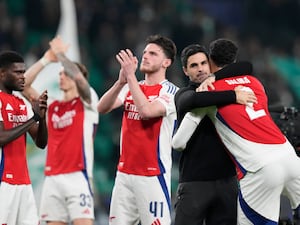 Mikel Arteta hugs William Saliba as Arsenal celebrate their win in Lisbon