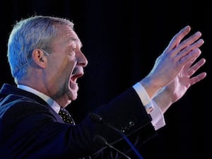 Nigel Farage raises his arms as he addresses a Reform UK regional conference