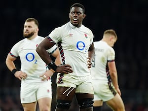 Maro Itoje, with his hands on his hips, looks on