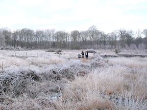 A family walk across Hothfield Common in frosty conditions near Ashford in Kent