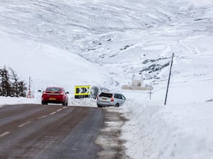 Cars driving in a snowy mountainous landscape