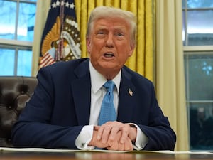 President Donald Trump speaks to reporters as he signs executive orders in the Oval Office