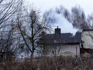 A smoke rises from the place where a DHL cargo plane crashed into a house near the Lithuanian capital Vilnius