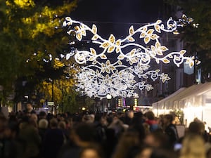 Crowds walk underneath Christmas lights in London's Marylebone