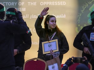 Agam Berger waves to the crowd as she is freed