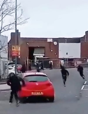 Footage shows the youths running through roads towards each other.