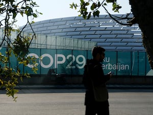 A person walks outside the Baku Olympic Stadium, the venue for the Cop29 summit