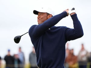 Tiger Woods plays a tee shot at the Open at Royal Troon in 2024