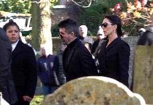 Simon Cowell and his fiancee Lauren Silverman arriving for the funeral service