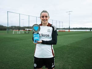 Ella Toone stands with the Barclays Women's Super League Player of the Month trophy