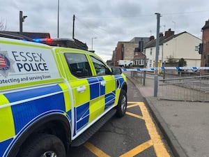 An Essex Police car and police tape in a street in Colchester