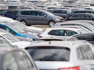 Cars lined up at a site in Corby