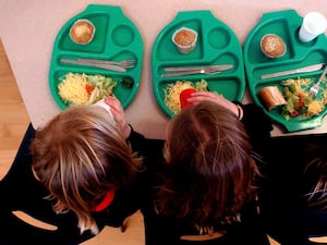 School children photographed from above eating from school dinner trays