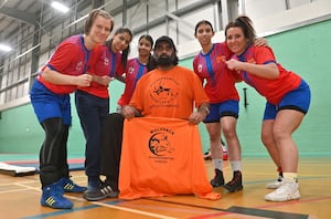 Ranjit Singh, and players. L-R:  Sima Pacenkaite, and Manpreet Kaur , Simanpreet Kaur, Imane Sibhi, Sally Hill.